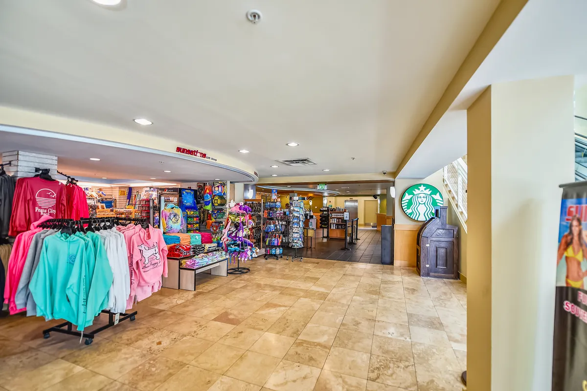 A vibrant on-site Starbucks with colorful merchandise displays, the recognizable Starbucks logo, and an open, welcoming layout. The scene invites socializing, coffee breaks, and a sense of daily comfort for guests.
