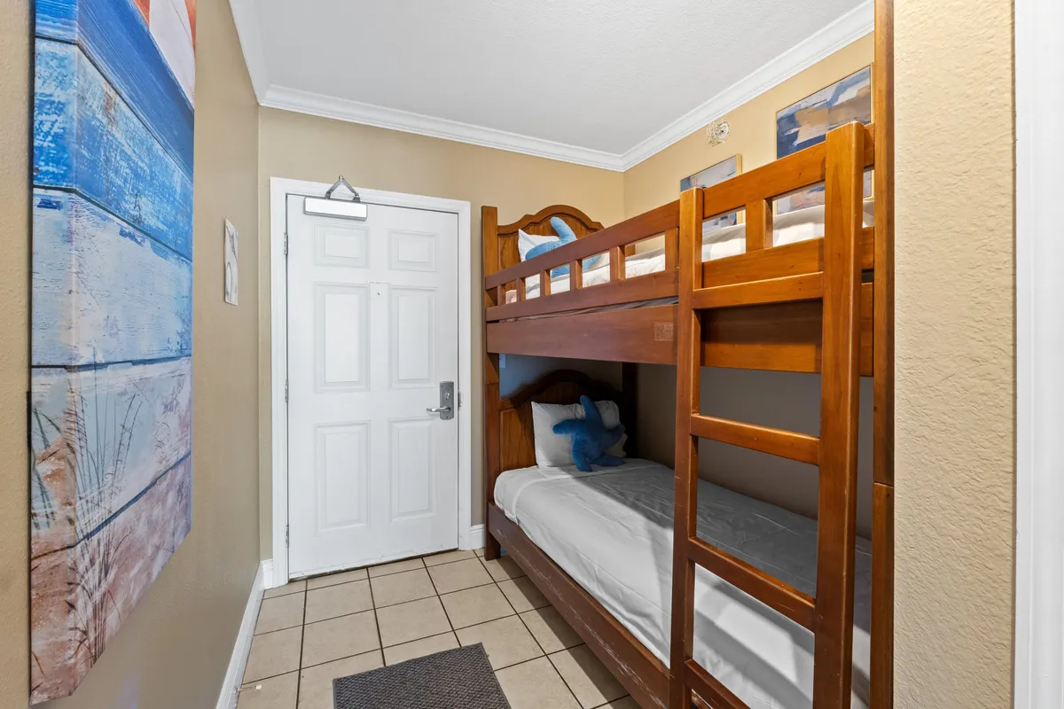 A playful and comfortable bunk nook with a sturdy bunk bed, colorful decorative painting, and a bright entrance area—perfect for kids to enjoy magical sleepover nights.
